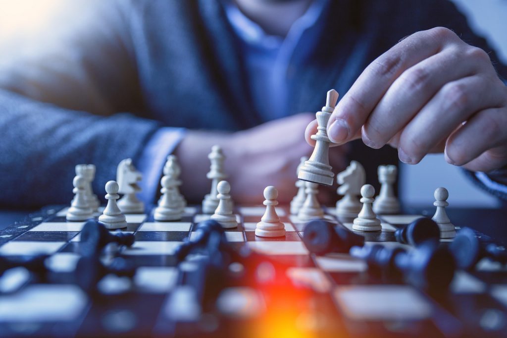 players playing chess after reading chess book