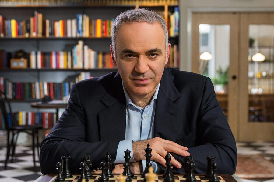 Garry Kasparov sitting infront of a chess board